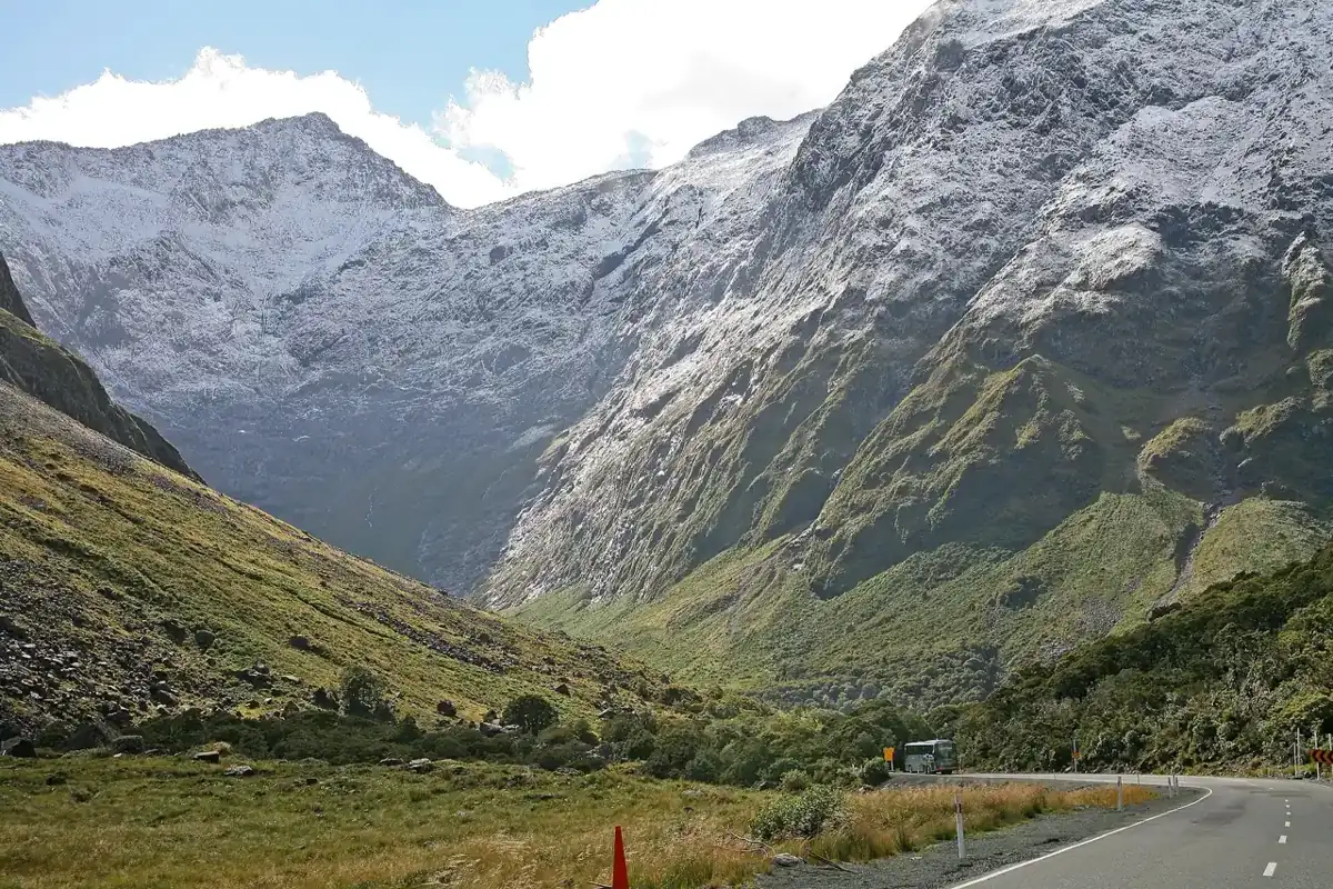 State Highway 94 winding up a glacial valley toward snow-streaked mountains